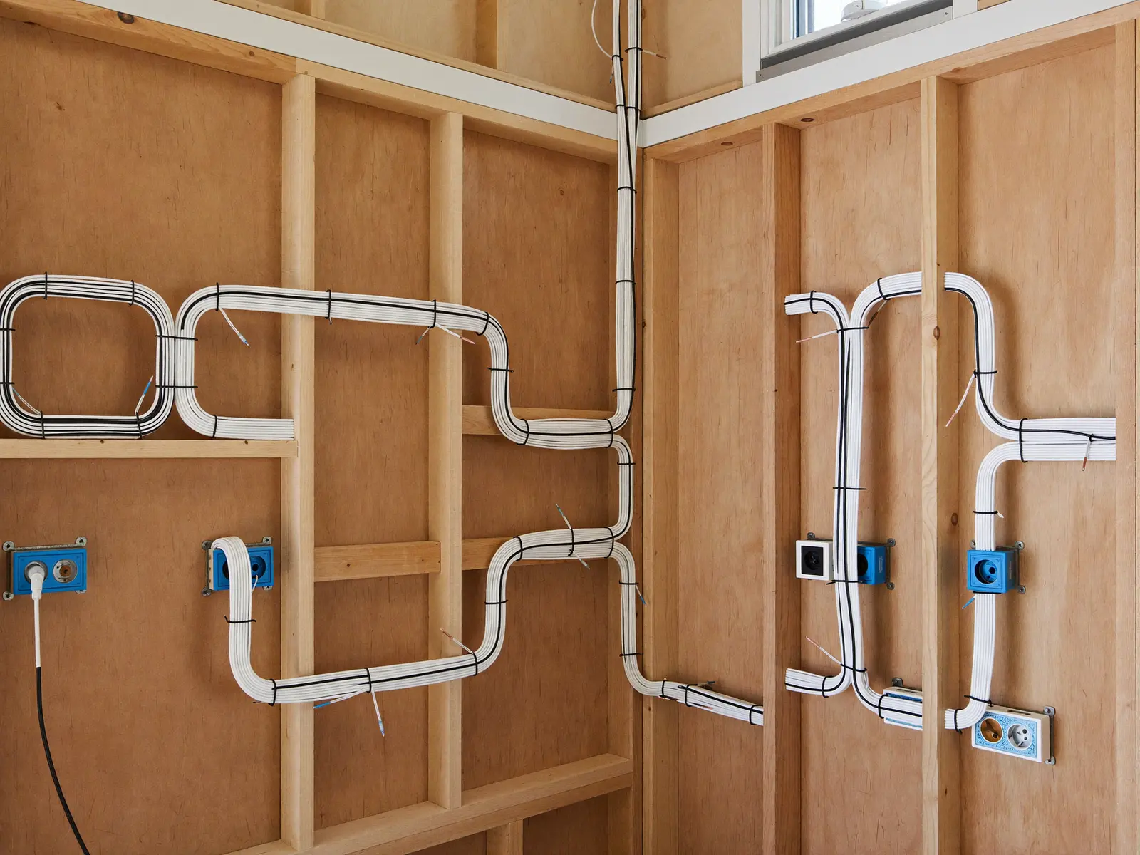 Neat new wiring runs stapled along framing